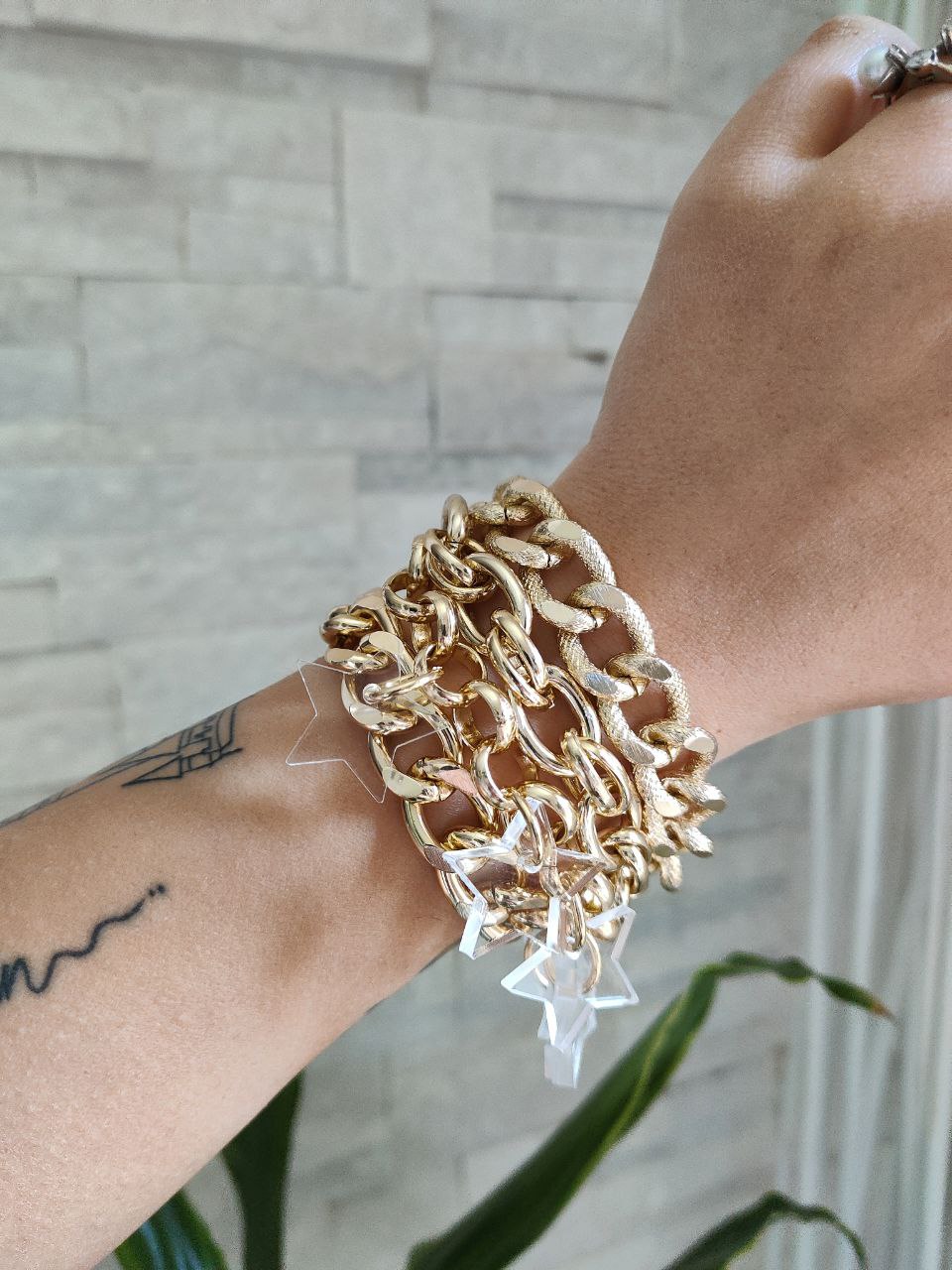 Bracciale oro con ciondoli stelle plexi